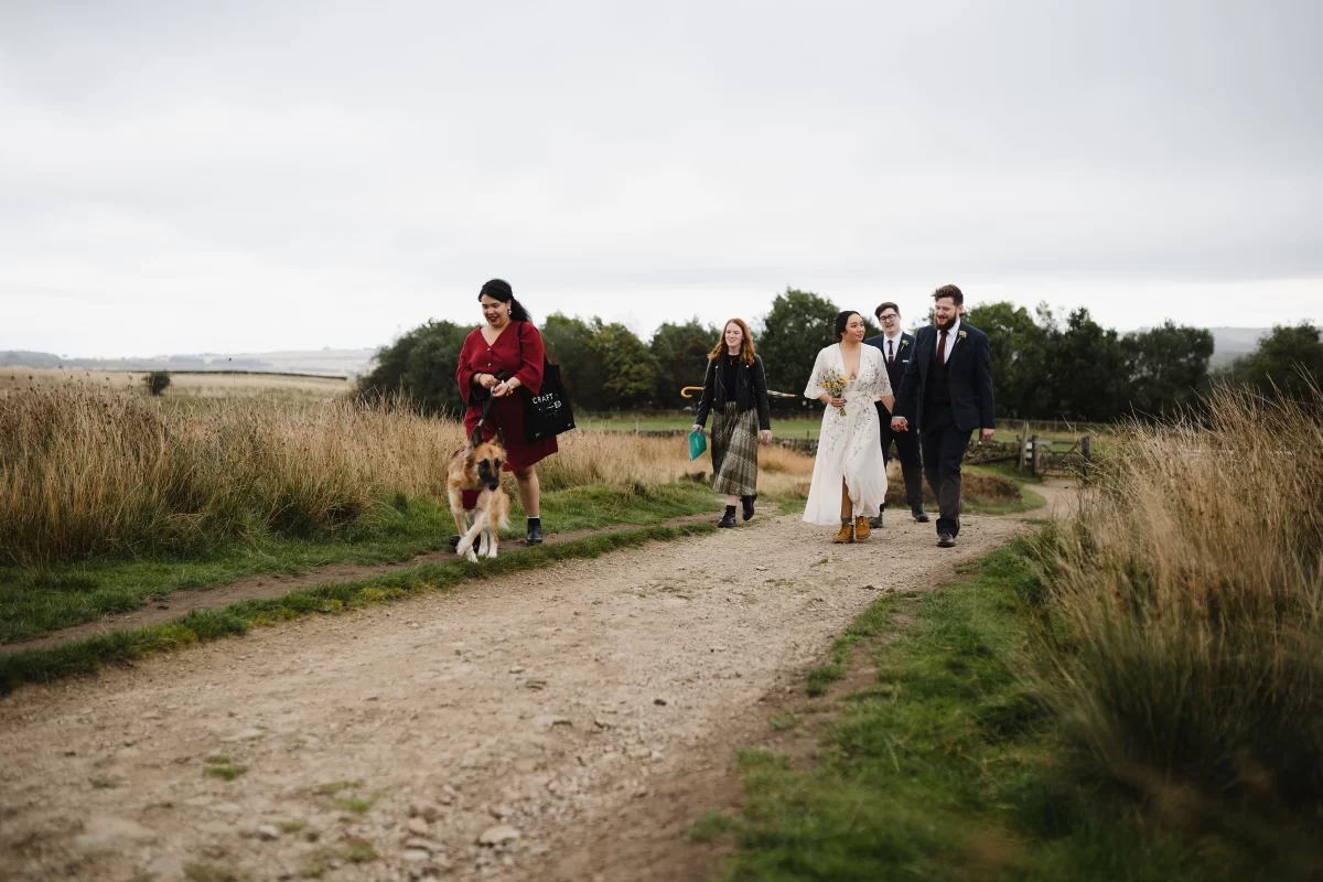 The tiny wedding party walk to the elopement location, five people in total