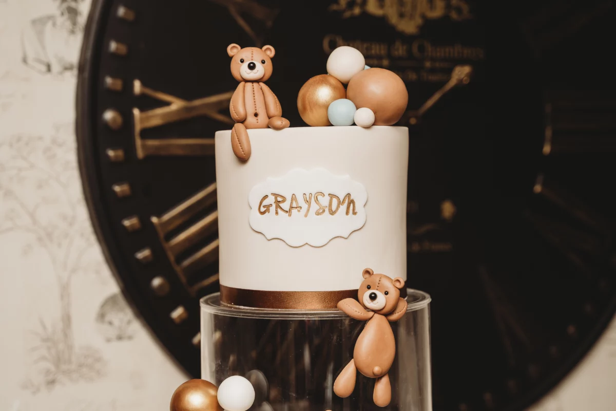 A cute cake with teddy bears and the name 'grayson'