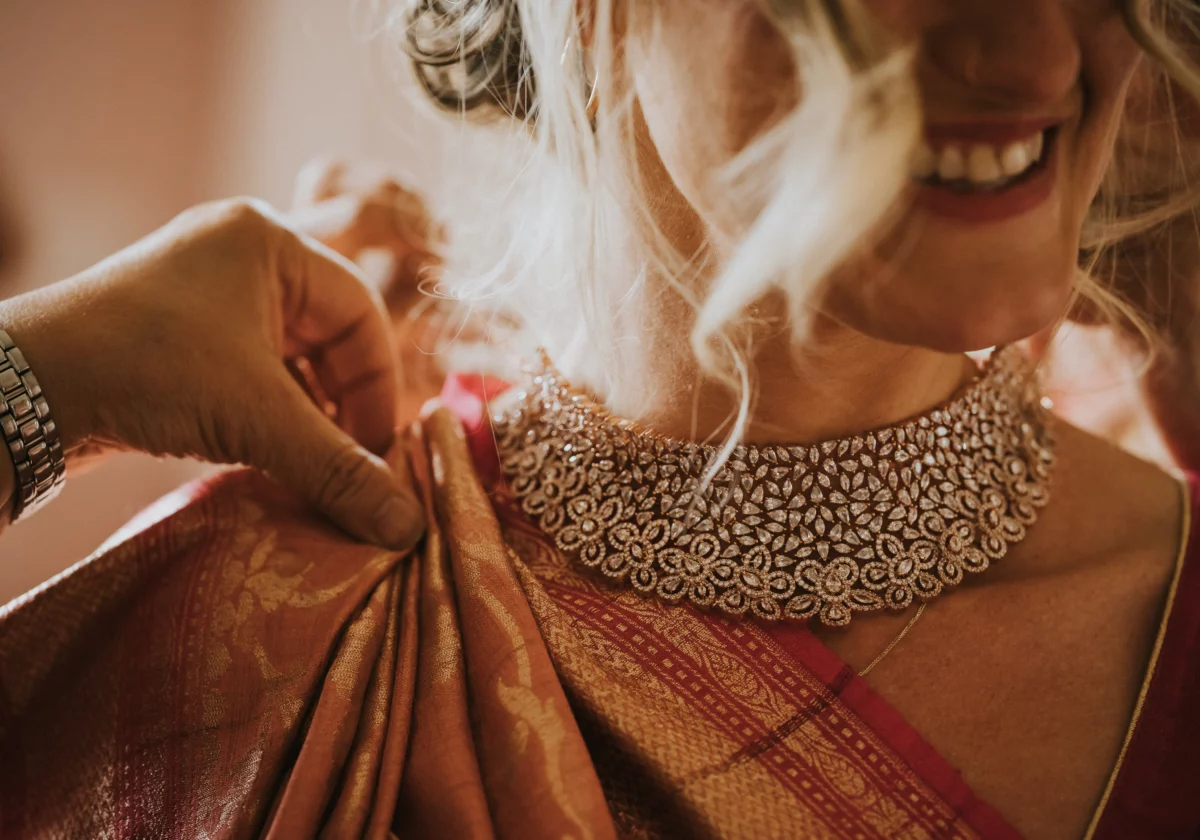 The bride's sari is pinned in place