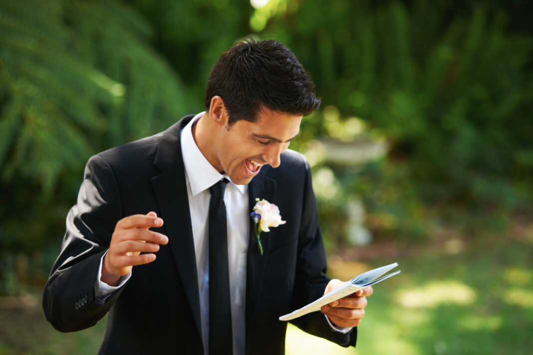 A man laughs as he gives a reading at a vow renewal