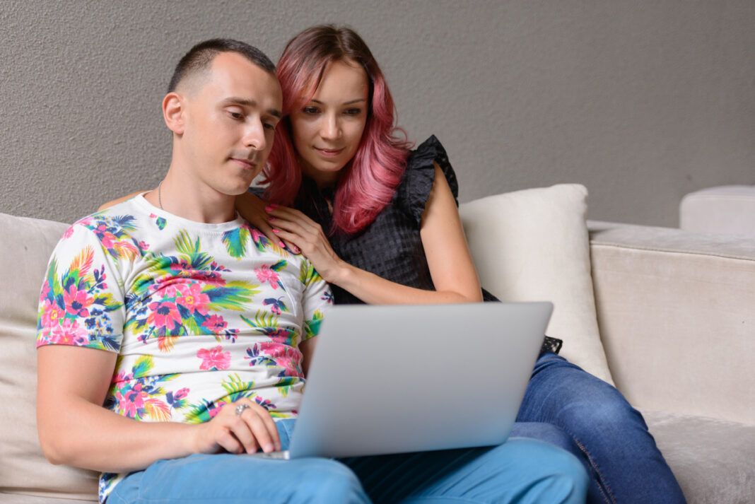 Couple watching online funeral